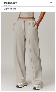 Detail of high waist light khaki sweatpants with elastic drawstring and vertical seam design