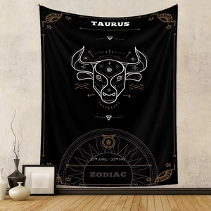 Detailed view of a black Taurus zodiac tapestry with gold stars in a cozy home setting