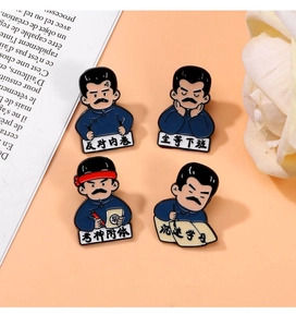 Detail of four Lu Xun cartoon enamel pins featuring humorous Chinese slogans on books