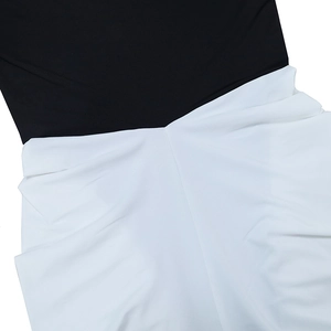 Détail du patchwork noir et blanc contrasté avec texture froncée sur cette robe élégante