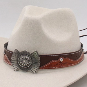 Detail of the brown leather decorative belt with silver conchos on the ivory fedora hat