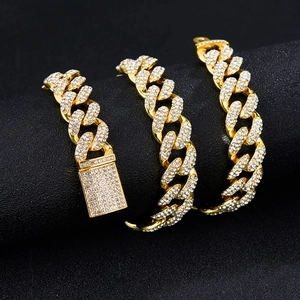 Hip hop gold plated Cuban link chain necklace with sparkling rhinestones on black background