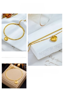 Close-up of gold titanium heart pendant with I Love You engraving and snake chain