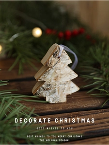 Rustic wooden Christmas tree ornament with natural bark texture on dark wood background