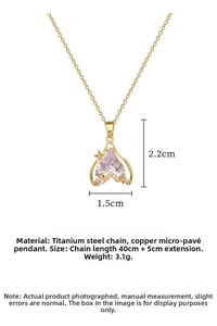 Macro view of gold heart pendant with purple gemstone and star detail, dimensions 2.2x1.5cm
