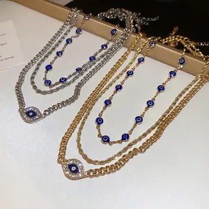 Chic layered necklace set with sparkling devil eye pendant on golden and silver chains