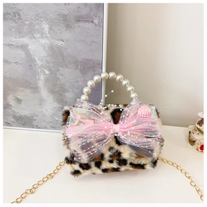 Detail of plush leopard print kid's bag with pearl handle and pink mesh bow accent