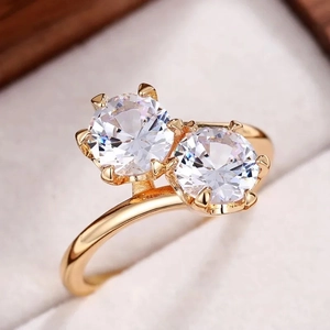 Sparkling double zircon ring with six-prong gold band in jewelry box for engagement
