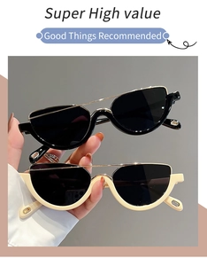Close-up of stylish black and beige semi-rimless cat-eye sunglasses with metal accents