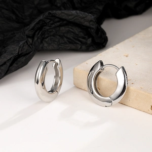 Close-up of S925 sterling silver stamp on thick hoop earring with a polished finish