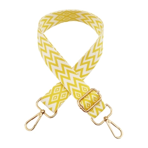 Detail of yellow and white diamond pattern canvas strap with gold metal lobster clasps