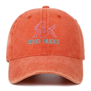 Close-up of rust orange baseball cap featuring vintage embroidery and cotton texture