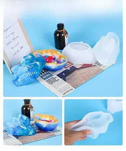 Macro view of swan-shaped silicone molds for resin storage box with finished blue sample