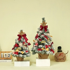 Mini artificial flocked Christmas tree set with red bows and burlap base for desk decor