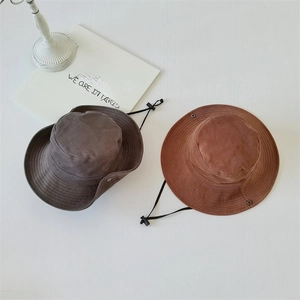 Detail of outdoor sun hats in dark grey and brown with adjustable windproof drawstrings