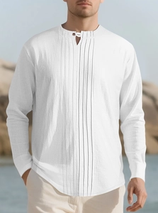 Detail of white pleated cotton linen long sleeve shirt featuring a single button collar