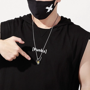 Detail of gesture pendant necklace with tiger eye stone on model in streetwear
