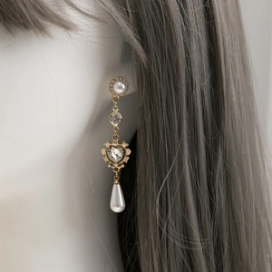 French vintage gold drop earrings with heart crystal and baroque pearls on a model
