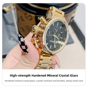 Detail of gold watch with black dial and scratch-resistant mineral crystal glass