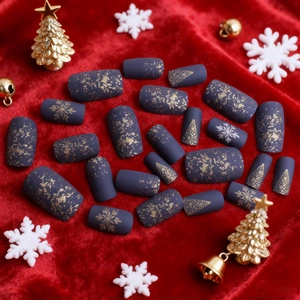 Christmas press-on nails with golden snowflakes and tree designs on purple matte finish