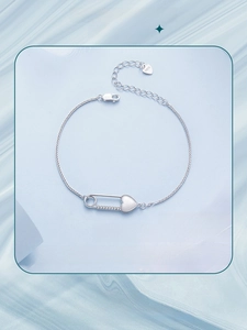 Detailed macro view of S925 sterling silver heart safety pin bracelet with zircon accents