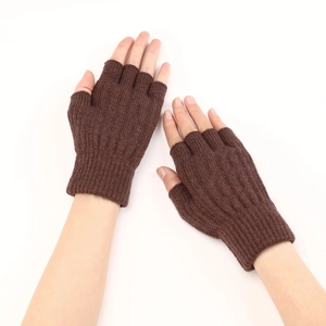 Close-up of brown cable knit fingerless gloves showing thick ribbed texture and soft material