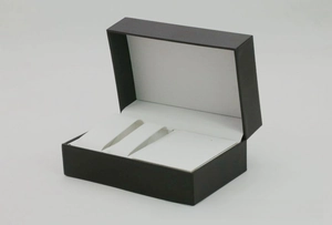 Detail view of the black PU leather watch box interior with white velvet slots