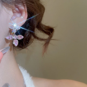 Detail of pink marquise zircon drop earrings on a model showing the silver-plated star design