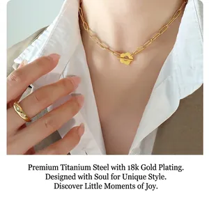 Detail of 18k gold plated titanium steel necklace with flower toggle clasp and star ring