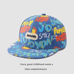 Detail of colorful graffiti smile print and GROOVE patch on blue hip hop flat cap