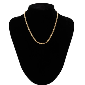 Detail of a triple-layered gold bead chain necklace featuring textured rectangular metal accents