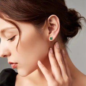 Vintage S925 silver square emerald stud earrings worn by a model in a close-up shot