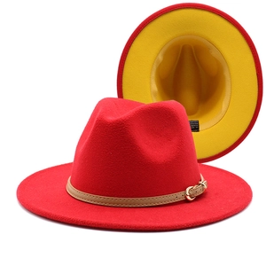 Detail view of two-tone wool fedora hat with red exterior and yellow lining