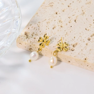 Elegant gold titanium clover earrings with white baroque pearl drops on stone base