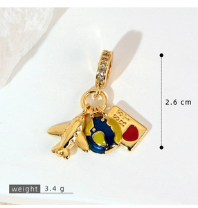 Macro detail of gold travel charms with plane, globe, and passport with measurements