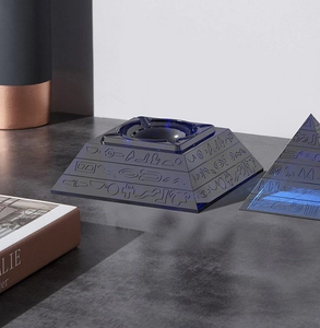 Detailed relief of Egyptian hieroglyphs on a translucent blue pyramid ashtray and ornament