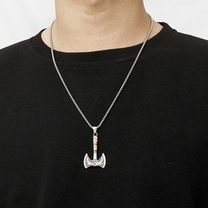 Viking raven axe necklace for men in silver and gold steel worn by a model