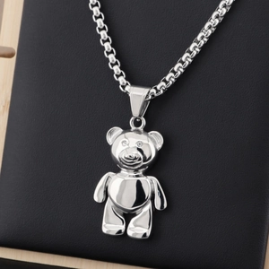 Polished silver panda pendant necklace with crystal eyes on a black leather display