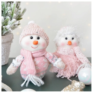 Detail view of plush pink and white Christmas snowmen with knitted hats and cozy scarves
