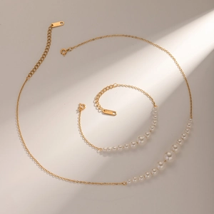 Macro detail of 18k gold stainless steel jewelry set with gradient pearl sizing