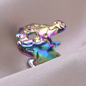 Macro shot of iridescent rainbow finish on an irregular stainless steel ring band