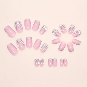 Flat lay of 24 pieces french press-on nails with silver glitter and rhinestone accents