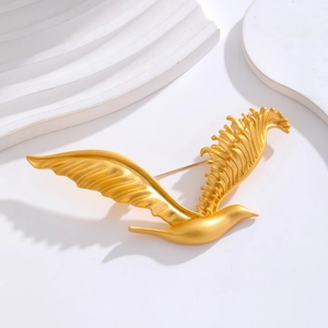 Macro shot of an elegant golden flying eagle brooch with a matte textured metal finish