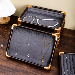 Walnut wood jewelry display tray with grey velvet lining and champagne gold metal frame