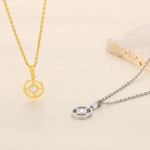Detail of hollow geometric cross necklaces in gold and silver with sparkling stones
