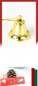 Close-up of golden Christmas bell with snowflake pattern and festive retail packaging