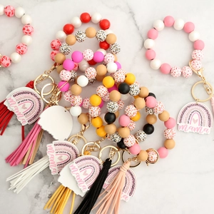 Leopard print wooden bead wristlet keychain with leather tassel and mama rainbow charm