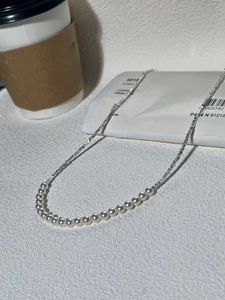 Elegant 8mm white pearl necklace with silver blocks and branded packaging display