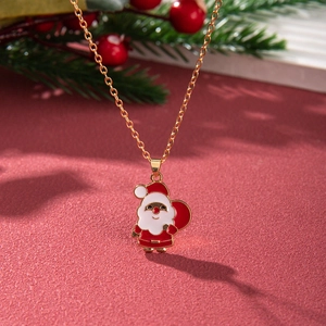 Detail of Santa Claus enamel pendant on gold chain with festive Christmas background