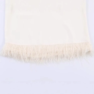 Fashionable white padded shoulder top with elegant fringe details for women